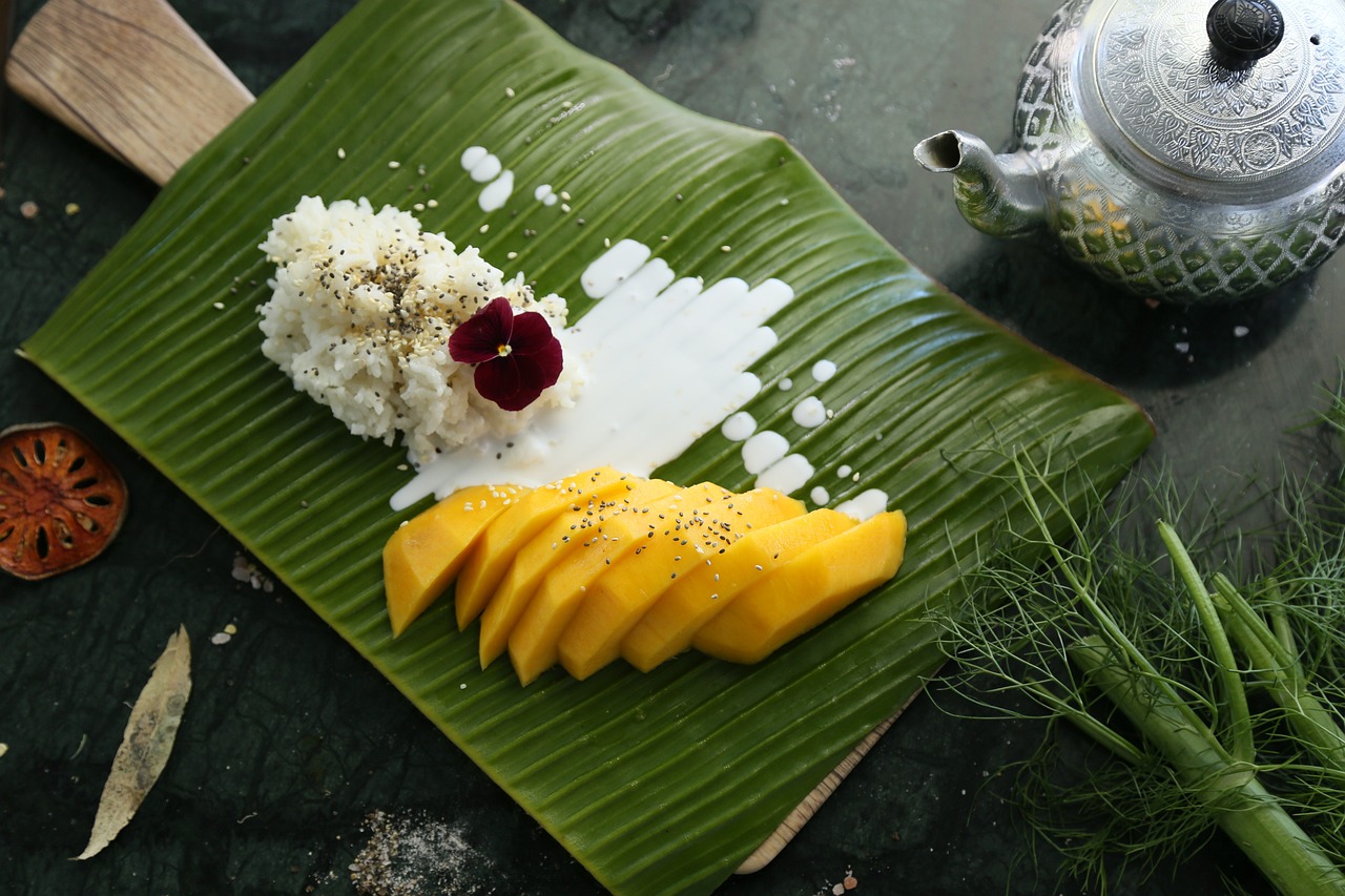 Traditional thai Mango sticky rice on a banana leaf